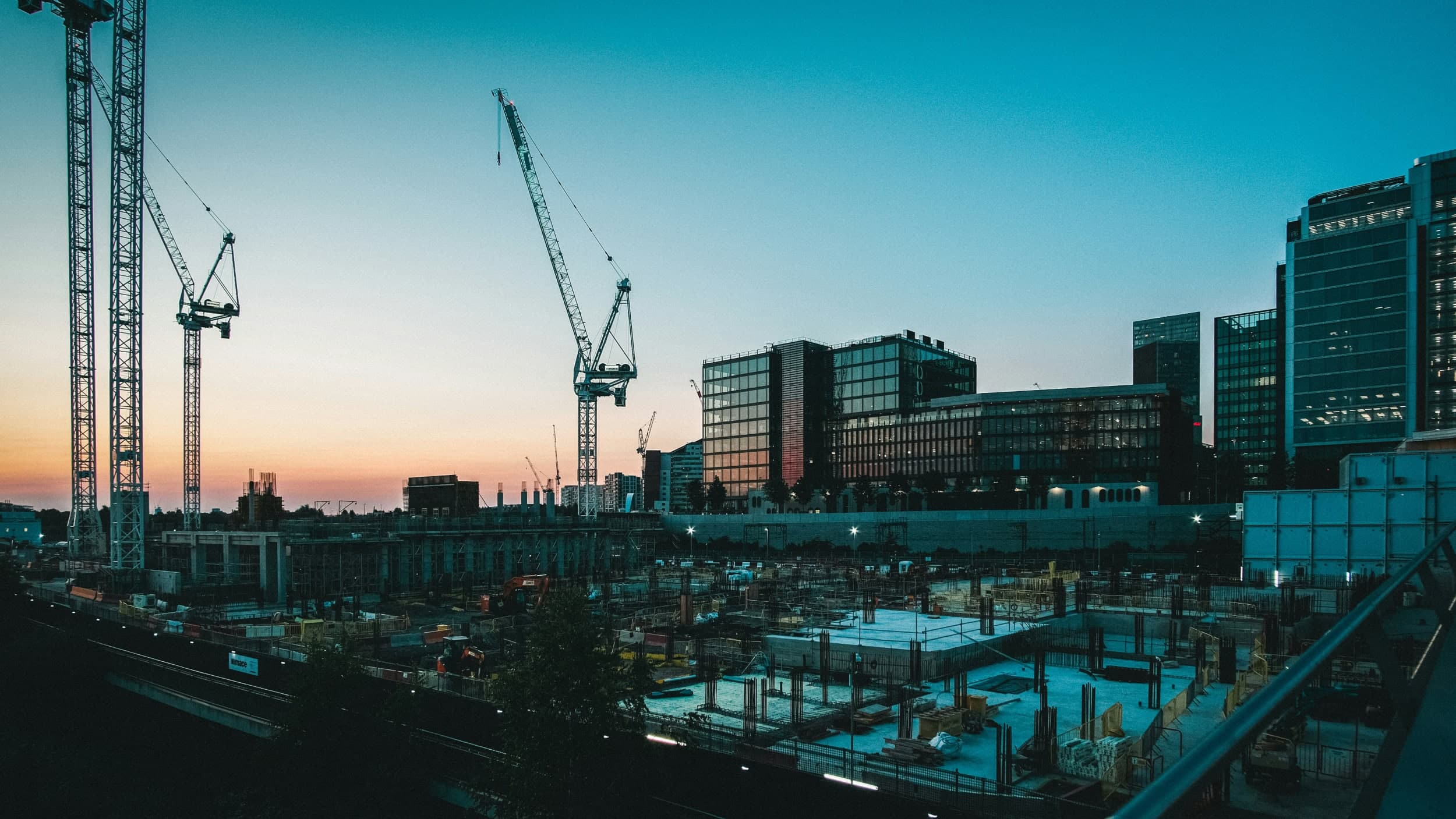 Development site cranes at sunset