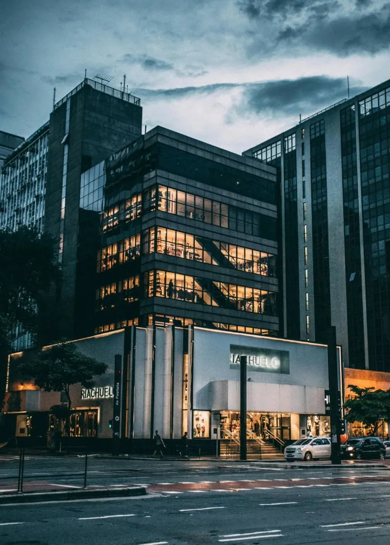Multi-storey commercial building with illuminated offices at dusk